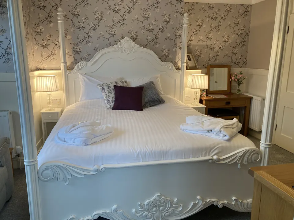 Double bedroom with floral wallpaper at Exmoor House